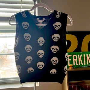 Black sweater vest with white skulls